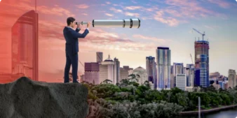 A suited man overlooking Brisbane with a telescope.