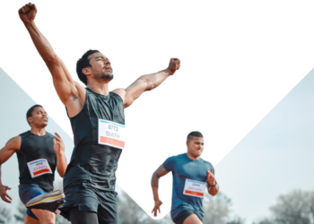 Men in a race as one crosses the finish line